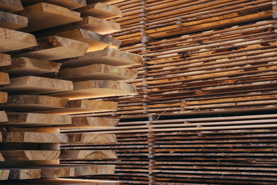 Sawn timber stacked in rows at a mill.